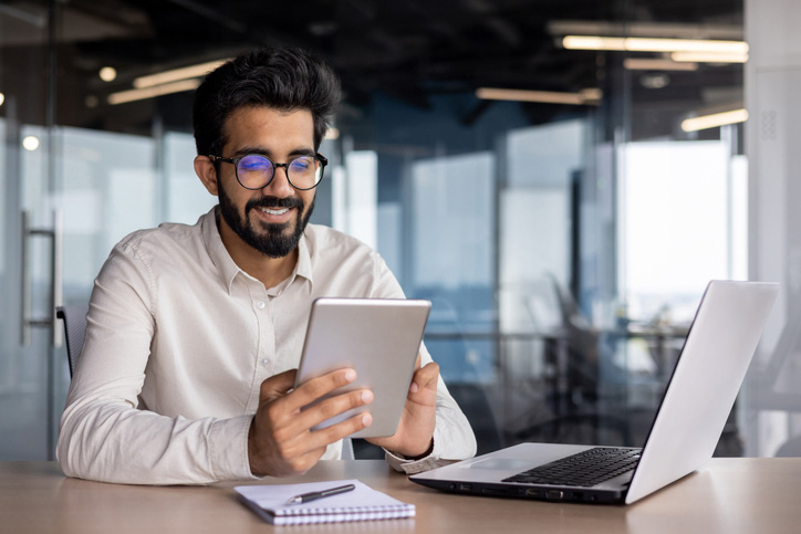 Business professionals analyzing financial data on a digital tablet
