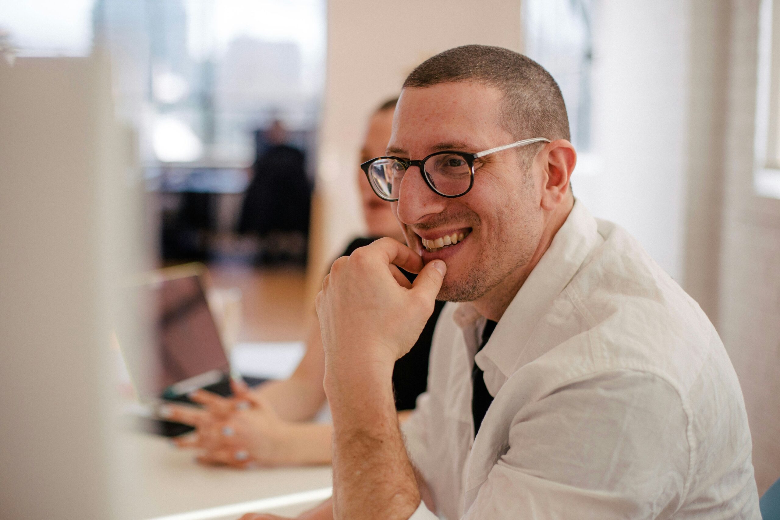 Business professional in a meeting, presenting data on a screen